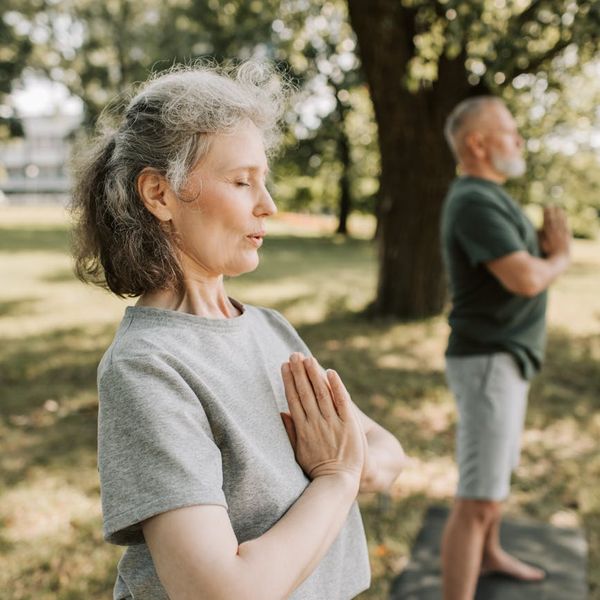 Person meditating calmly in a well-lit, serene environment.